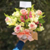 This arrangement is delivered in a white ceramic and features soft pink