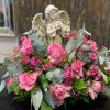 This peaceful angel sculpture, surrounded by roses and delicate greenery is a