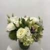 This exquisitely arranged bouquet radiates serene beauty and sophisticated charm. It features
