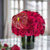 Experience the timeless elegance of our arrangement featuring exquisite red roses in