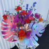 This fresh and vibrant arrangement is sure to be an eye catching