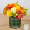 This floral arrangement encapsulates the colors of fall in a bright and
