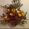 Beautiful bright red, orange and blush flowers in a basket expresses commiseration