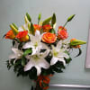 Vase arrangement with roses and lilies.