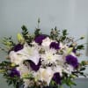 Box arrangement with mums, lilies, roses, cushion daisies, and lisianthus.