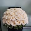 Box arrangement with two dozen white roses. 
