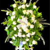 This delicate White sympathy standing spray is composed of White Roses, Carnations