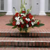 SEND YOUR SINCERE CONDOLENCES WITH THIS STUNNING CLASSIC WHITE AND RED ARRANGEMENT.