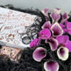 A beautiful display in a wooden crate filled with purple florals, and
