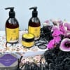 A beautiful display in a wooden crate filled with purple florals, and