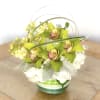 Simple and elegantly arranged cymbidium orchids and hydrangeas accented with dusty miller