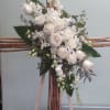 Bamboo cross with white roses and orchids.