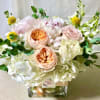 medium size floral in white glass vase fill with fabulist seasonal flowers