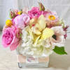 medium size floral in white glass vase fill with fabulist seasonal flowers