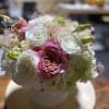 medium size floral in white glass vase fill with fabulist seasonal flowers