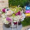 medium size floral in white glass vase fill with fabulist seasonal flowers