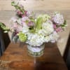 medium size floral in white glass vase fill with fabulist seasonal flowers