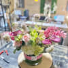 medium size floral in white glass vase fill with fabulist seasonal flowers