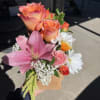 Flowers arranged in to-go cup holder,  drink on the other side