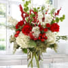Experience the beauty of red roses, complemented by the charming bells of