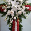 Cross with red and white carnations, white roses, white lilies, and white