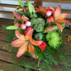 This vase of lilies, roses and a variety of fun accents is
