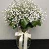 Vase arrangement of soft and dainty babies breath, tied with a soft