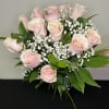Wrapped bouquet of light pink roses with babies breath, ready to go