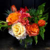 This stunning arrangement features warm colors with a variety of roses, tulips