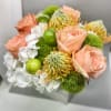 Wooden box fill with seasonal flowers combination .
Very popular floral arrangement with