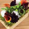 Wooden box fill with seasonal flowers combination .
Very popular floral arrangement with
