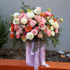 A mix of colorful flowers mixed in a cylindric box