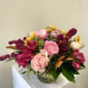 Beautiful Magnolia leaves with pink, crimson and sunset colored flowers.