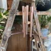 Rose gold chimes with a wooden clapper bearing the sentiment &quot;The Memory