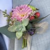 This boutonni&egrave;re created with a succulent, berries and mums. 