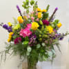 A beautiful, grand, colorful vase arrangement that has a little bit of