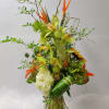 This arrangement has Birds of Paradise, Cymbidium, Hydrangea, Pineapple, Lily, Solidago, Thistle