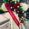 This tribute is composed of White Carnations and a spray of 12