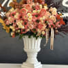 A vibrant arrangement of orange and peach flowers, blending warm, rich hues