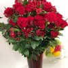The elegant composition in a vase of red roses and alstroemeria is