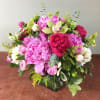 Variety of peonies, green cymbidium and mix greens all arrange in a