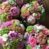 This arrangement contains peonies, hydrangeas, lisianthus, roses.
