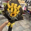 8 ROSES WITH A SUNFLOWER IN THE MIDDLE WRAPPED WITH BLACK KOREAN
