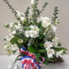 Red white and blue bow is highlighted by a bouquet of white