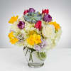 This arrangement includes hydrangea, tulips, freesia, succulents and other seasonal blooms. This