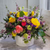 A cute spring basket with bright colors accented with curly willow and