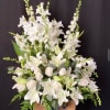 Arrangement of Gladiolas, Lilies, 12 white roses and foliage.