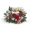 Thomas Kinkade inspired candy shop atop Christmas greens and flowers.  The