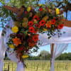 Beautiful gerberas highlight this beautiful wedding arbor adornment.  