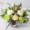 Green Hydrangea, white cremon, white alstroemeria, white veronica, white stock, and pine
